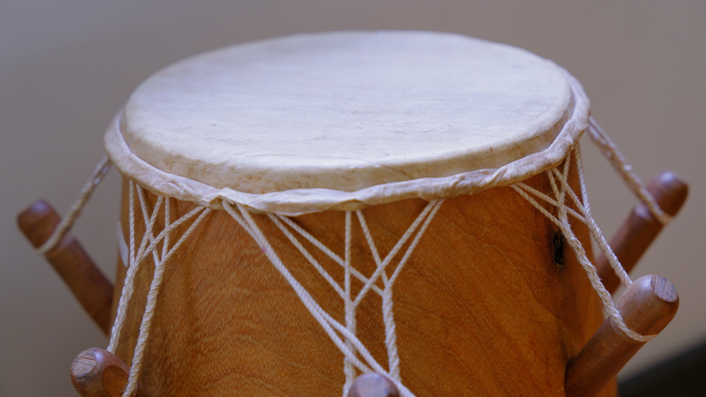 Close-up of a hand drum with natural skin head and rope tuning